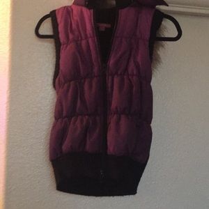 Purple vest with a hood with fur around it.